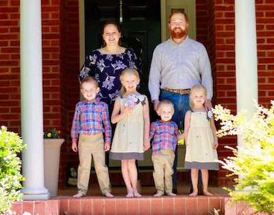 Ryan McKibben with family on front porch